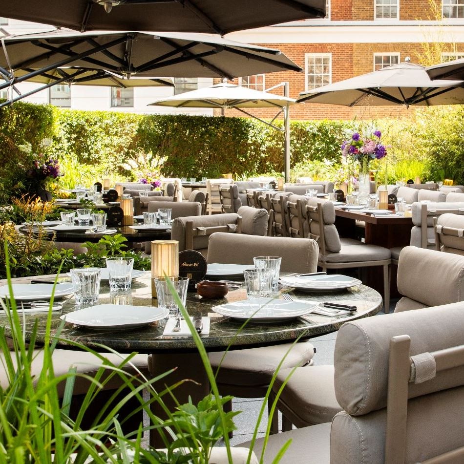 Elegant rooftop dining setup at Nusr-Et London Knightsbridge, ideal for private events, cocktail receptions, and summer celebrations in a lush, upscale garden setting.