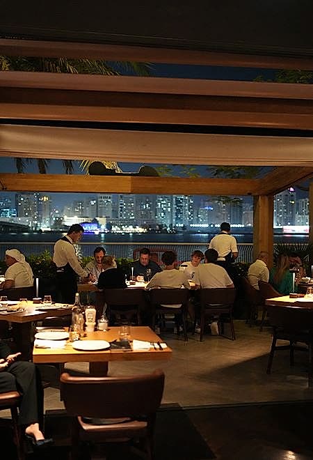 Nusr-Et Abu Dhabi waterfront restaurant: Guests savor premium steak dinners with a stunning view of the illuminated Abu Dhabi skyline