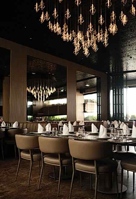 Elegant dining space at Nusr-Et Dubai, located within Dubai Four Seasons Hotel, featuring modern chandeliers and a luxurious setting for an upscale steakhouse experience.