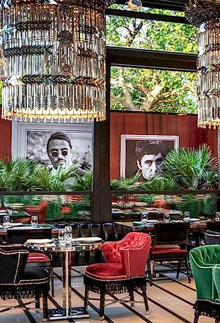 Artistic dining atmosphere at Nusr-Et Etiler, featuring modern artwork, lush greenery, and luxurious seating in a refined setting.