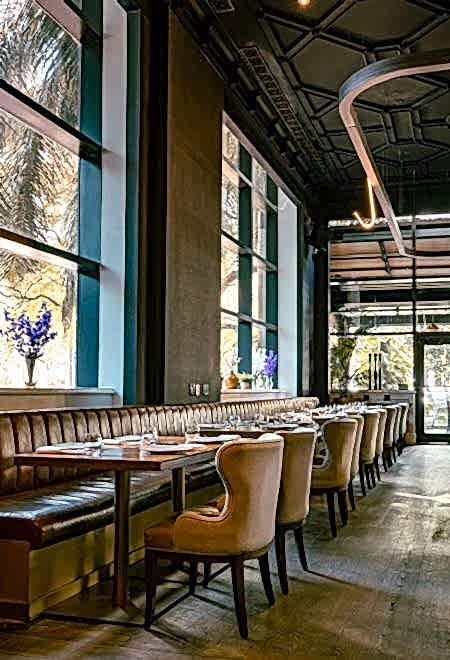 Chic and cozy dining area at Nusr-Et Miami, with large windows and plush seating, offering a refined and intimate dining experience.