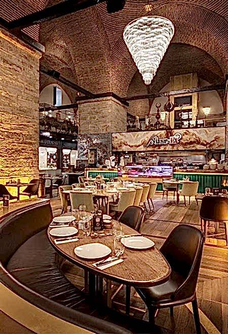 Grand central dining area under a vaulted ceiling at Nusret Kapalı Çarşı, Istanbul, offering a luxurious and unique steakhouse ambiance.